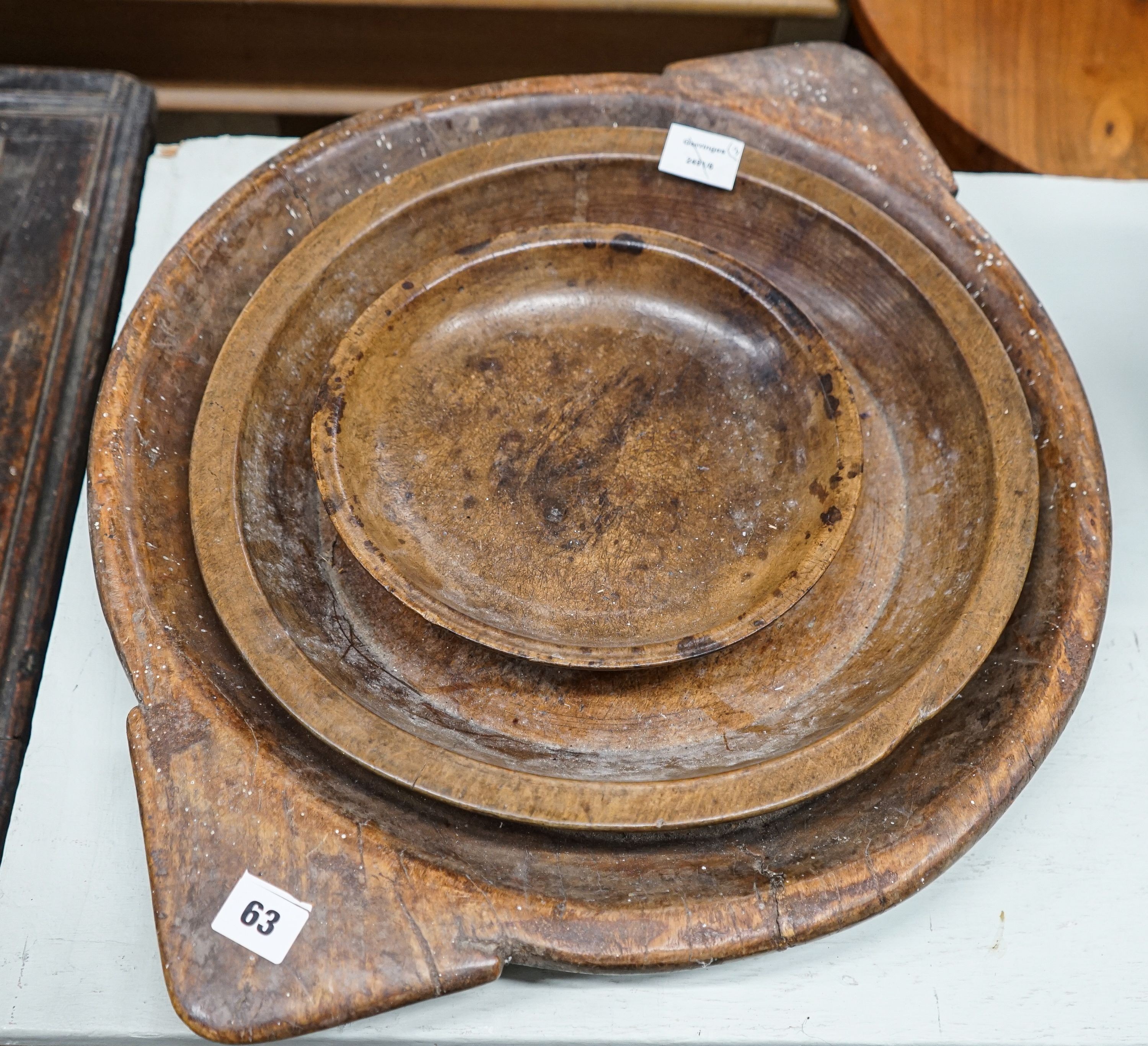 An early 19th century sycamore shallow bowl with lug handles, 64cm and two other bowls, 40cm and 26cm